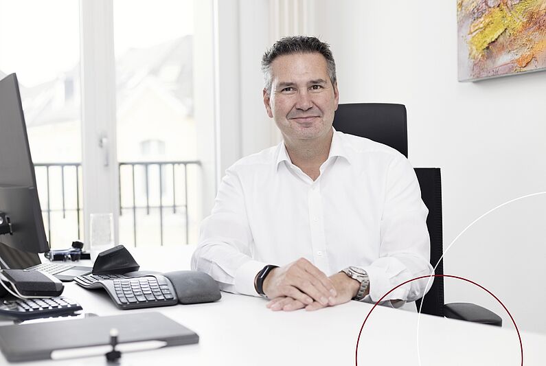 Christian Huschke sitzt an seinem Schreibtisch