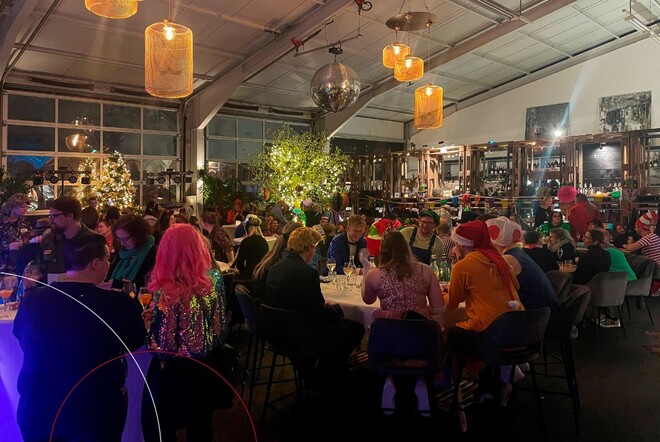 Die ttp-Mitarbeiter sitzen verkleidet an langen Tischen