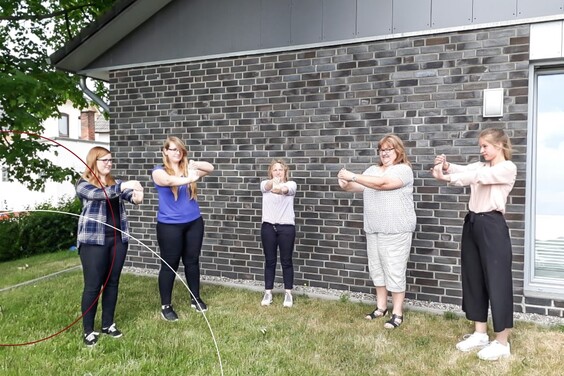 Fünf ttplerinnen machen Dehnübungen