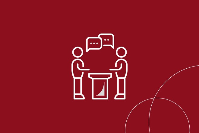 Grafik von zwei Männchen mit Sprechblasen an einem Tisch 